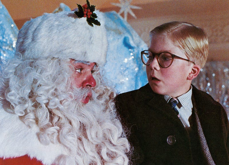 Peter Billingsley sits on Santa's lap in a scene from the film 'A Christmas Story', 1983.