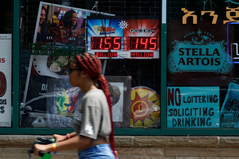 An electronic sign advertises the Mega Millions and Power Ball jackpot amounts outside a convenience store on August 07, 2023 in Silver Spring, Maryland. The Mega Millions jackpot is projected to reach an estimated $1.55 billion for its next drawing on Tuesday, the lottery’s largest prize ever. (Photo by Chip Somodevilla/Getty Images)