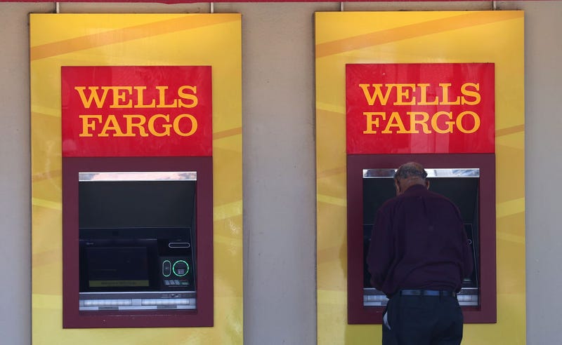 Wells Fargo customers use the ATM at a bank branch on August 08, 2023 in San Bruno, California.