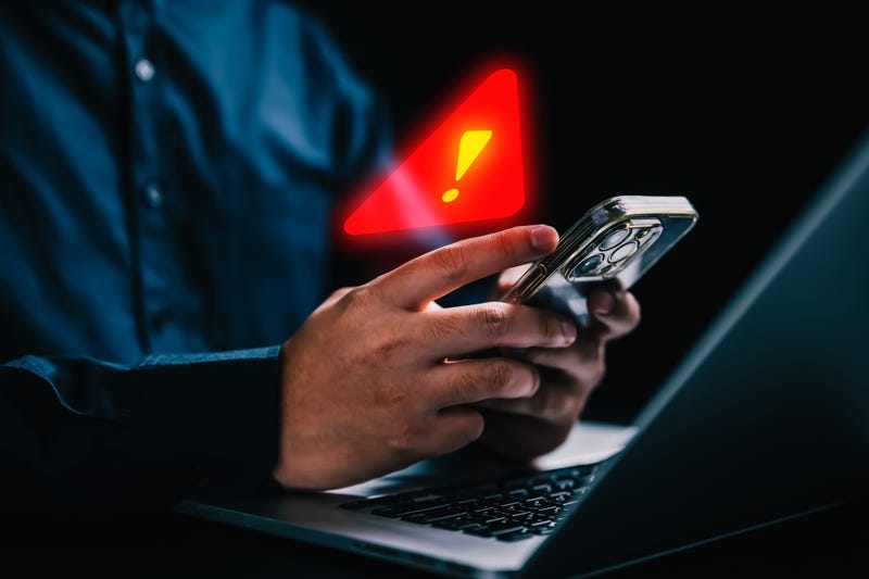People with warning notification and spam message icon on mobile phone