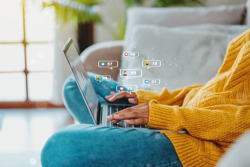 FILE: Woman using social media on a computer.