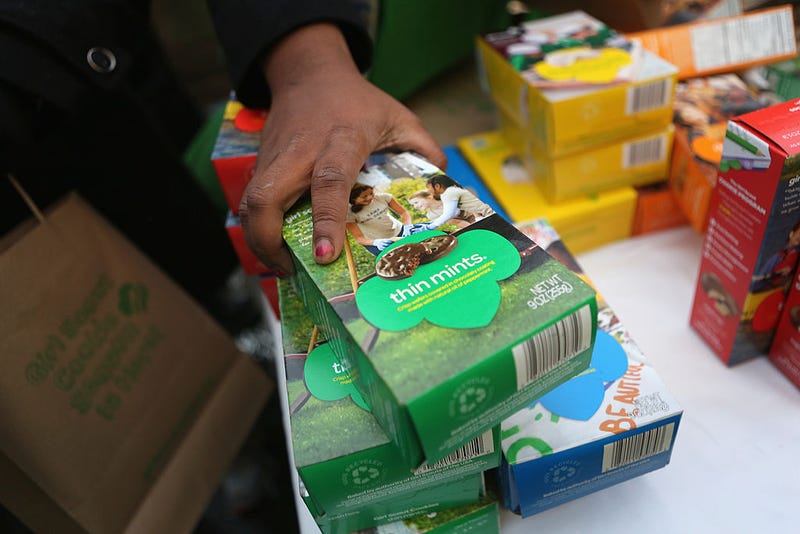 Girl Scouts sell cookies as a winter storm moves in on February 8, 2013 in New York City. The scouts did brisk business, setting up shop in locations around Midtown Manhattan on National Girl Scout Cookie Day.  