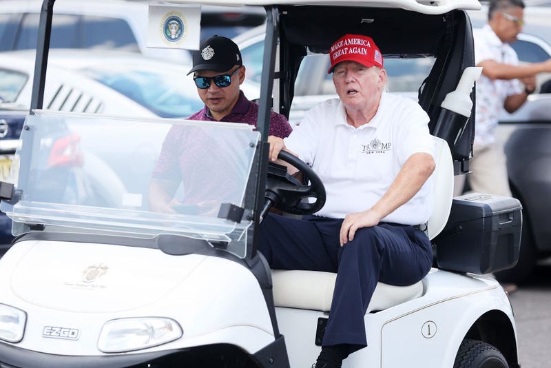 Former President Donald Trump drives a golf cart accompanied by aide Walt Nauta prior to the start of day three of the LIV Golf Invitational - Bedminster at Trump National Golf Club on August 13, 2023 in Bedminster, New Jersey. (Photo by Mike Stobe/Getty Images)