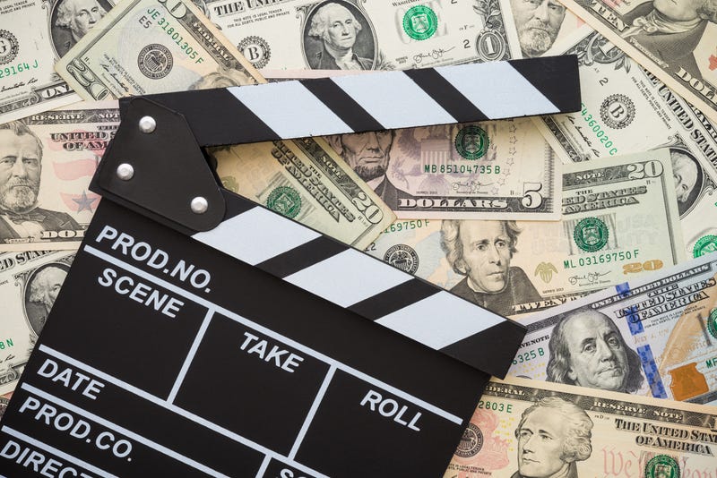 clapboard on stack of money