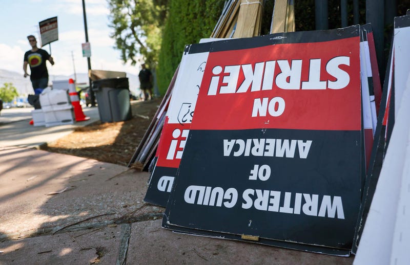 WGA (Writers Guild of America) strike signs are collected after a picket outside Disney Studios on August 16, 2023 in Burbank, California.
