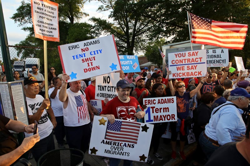 People attend a protest against the "tent city" for migrants at Creedmoor Psychiatric Center in Queens on Aug. 16, 2023
