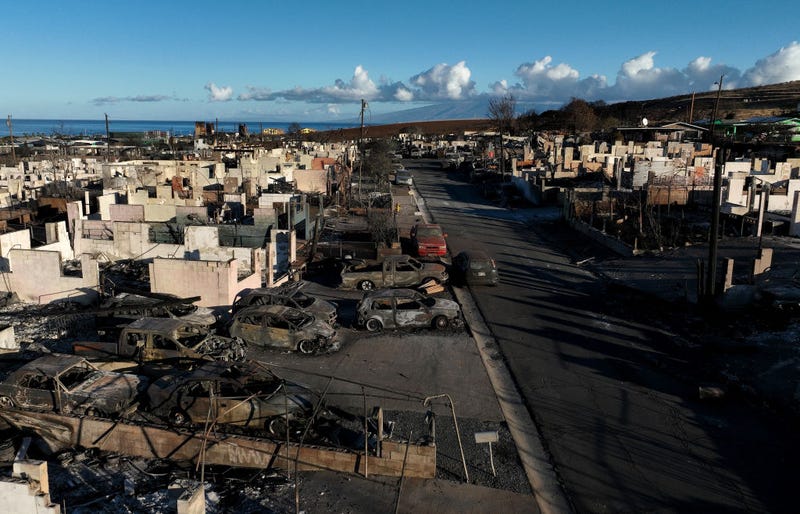 n an aerial view, burned cars and homes are seen in a neighborhood that was destroyed by a wildfire on August 18, 2023 in Lahaina, Hawaii.
