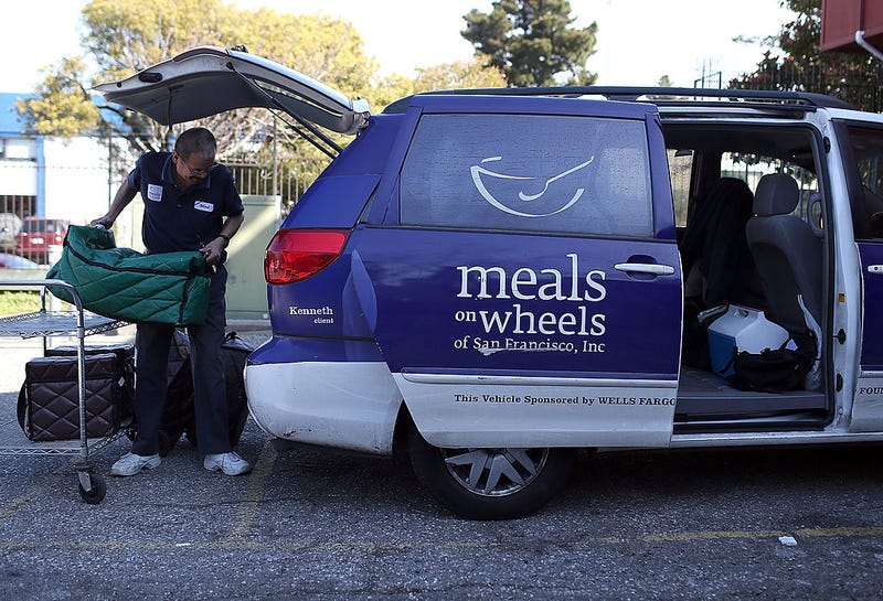 A Meals On Wheels of San Francisco driver loads meals into a van before making deliveries on February 27, 2013 in San Francisco, California.