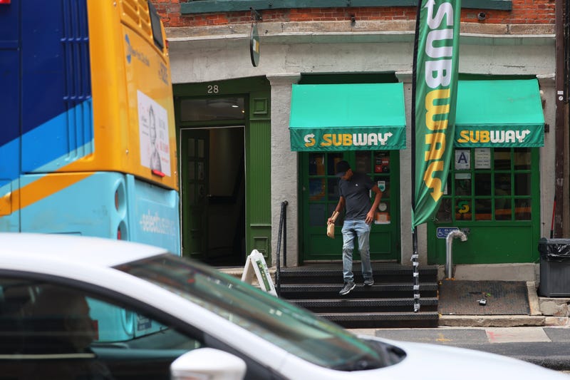 A person walks out of a Subway sandwich store in New York City. 