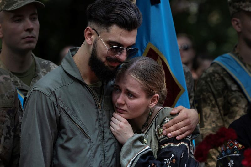 Friends and relatives mourn the death of fighter pilot Andrii "Juice" Pilshchykov, 30, who was killed along with two other pilots in a tragic mid-air plane crash in Kyiv, Ukraine on August 29, 2023. Andrii Pilshchykov was known as an excellent communicator trying to reform the Ukraine Air Force, lobbying hard for the F-16 fighter jets to be sent to Ukraine. (Photo by Paula Bronstein /Getty Images)