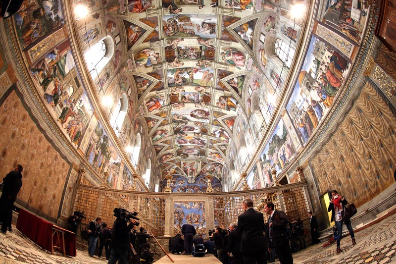 Media arrive as clergy and workers make arrangements in the Sistine Chapel before the papal conclave on March 9, 2013 in Vatican City, Vatican.