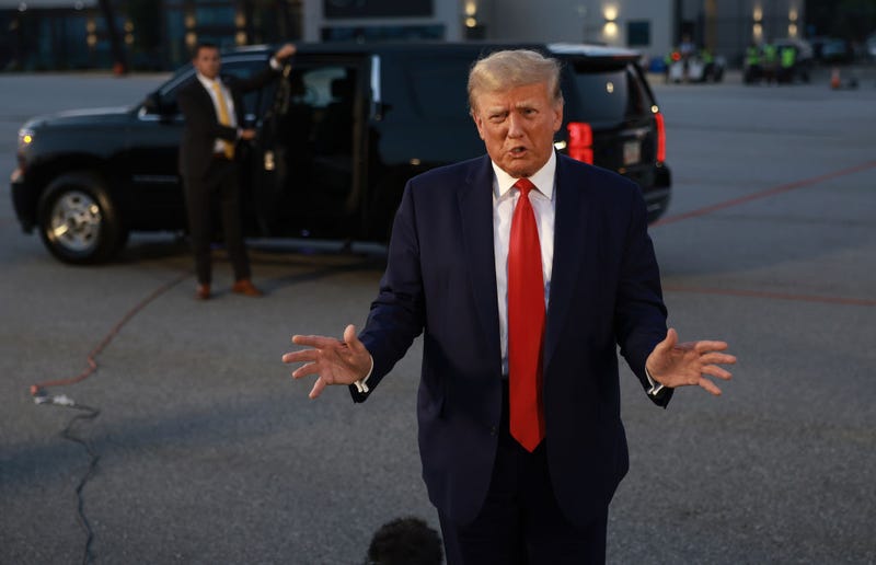 Former U.S. President Donald Trump speaks to the media at Atlanta Hartsfield-Jackson International Airport after surrendering at the Fulton County jail on August 24, 2023 in Atlanta, Georgia. Trump was booked on multiple charges related to an alleged plan to overturn the results of the 2020 presidential election in Georgia. (Photo by Joe Raedle/Getty Images)