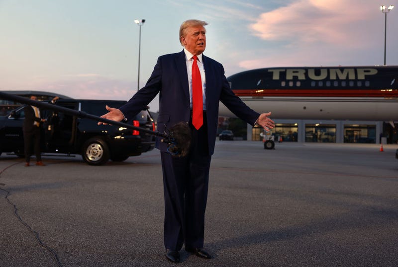 Former U.S. President Donald Trump speaks at Atlanta Hartsfield-Jackson International Airport after surrendering at the Fulton County jail on August 24, 2023 in Atlanta. Trump was booked on multiple charges related to an alleged plan to overturn the results of the 2020 presidential election in Georgia.