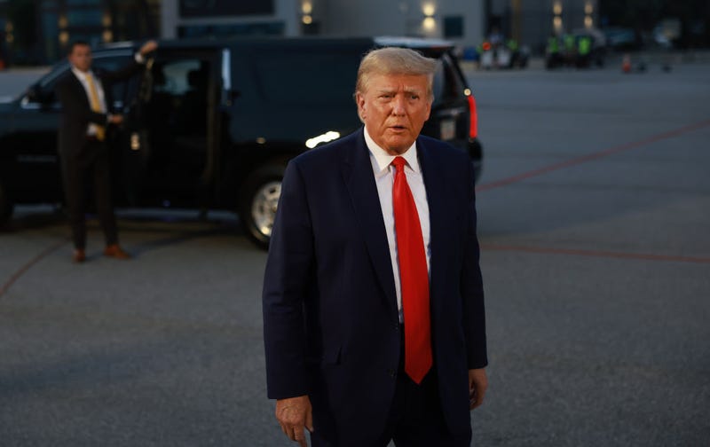 Former U.S. President Donald Trump speaks to the media at Atlanta Hartsfield-Jackson International Airport after being booked at the Fulton County jail on August 24, 2023 in Atlanta, Georgia.