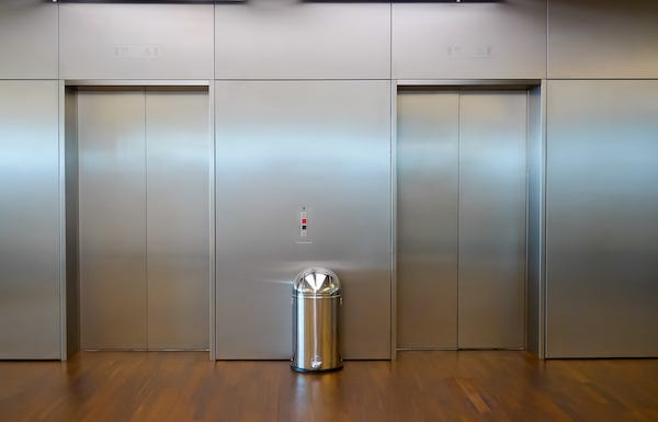 Trash can in elevator lobby