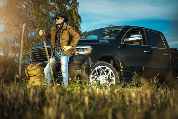 Farmer standing next to pickup truck