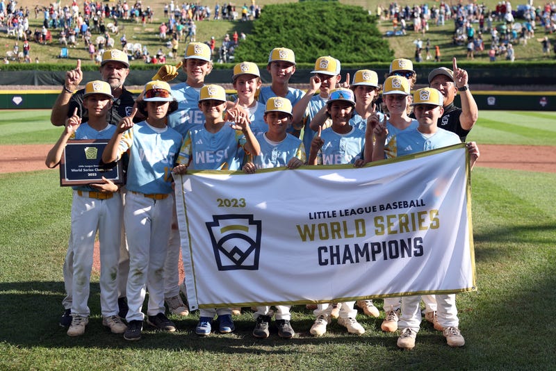 Members of the West Region team from El Segundo, California pose with the championship banner after defeating of the Caribbean Region team from Willemstad, Curacao to win the Little League World Series Championship Game at Little League International Complex on August 27, 2023 in South Williamsport, Pennsylvania.