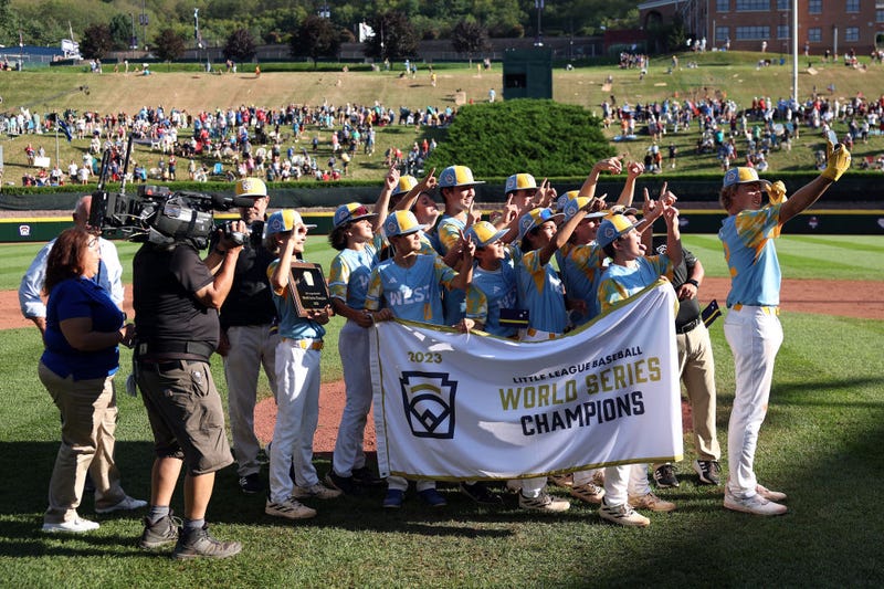 Members of the West Region team from El Segundo, California pose with the championship banner after defeating of the Caribbean Region team from Willemstad, Curacao to win the Little League World Series Championship Game at Little League International Complex on August 27, 2023 in South Williamsport, Pennsylvania.