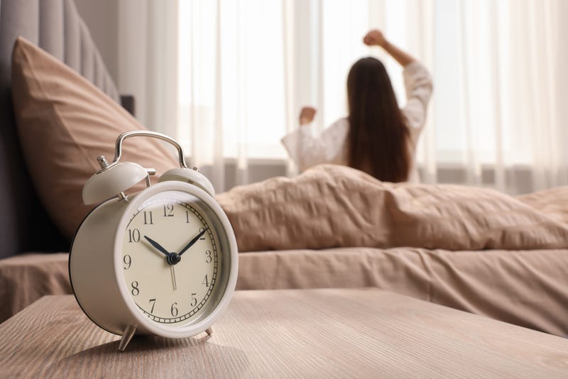 person stretching next to a clock
