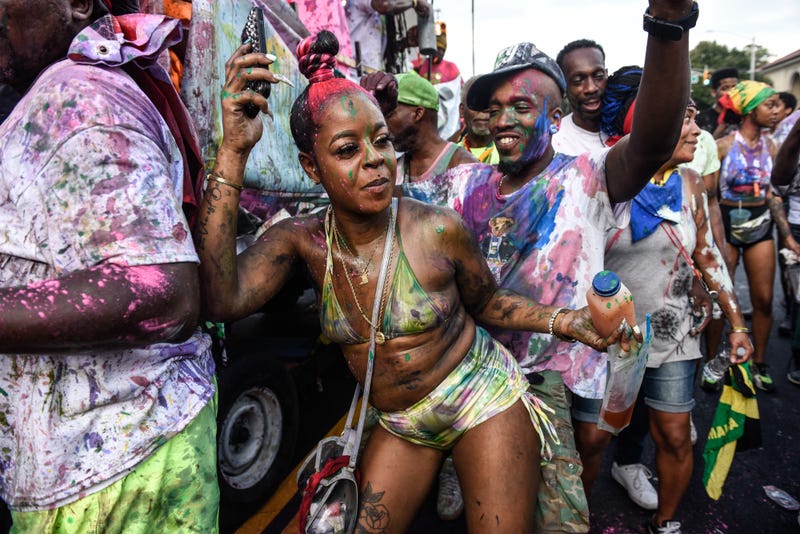 People cover themselves with paint and powder called "playing mas" during a Caribbean street carnival starting at dawn called J'Ouvert on September 4, 2023 in the Brooklyn borough in New York City. J'Ouvert originates from the French words "jour ouvert," meaning daybreak and signals the start of Carnival. Carnival is the traditional street festival honoring the vast heritage and culture of the Caribbean diaspora.