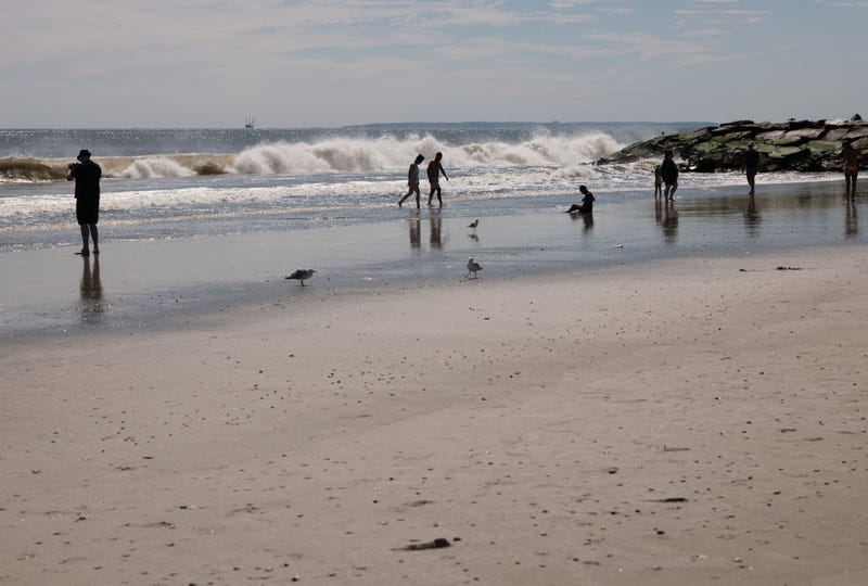 People enjoy a day at Rockaway Beach in New York as high surf from Hurricane Franklin delivers strong rip tides and large waves to most of the Eastern seaboard on Aug. 31, 2023. Numerous beaches across New York and Long Island were closed to swimming as a result.