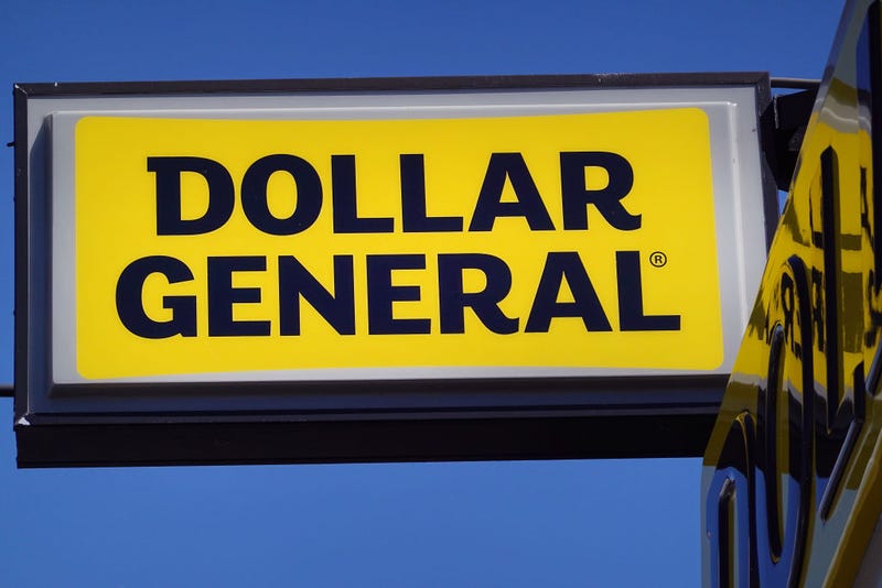 A sign hangs above a Dollar General store