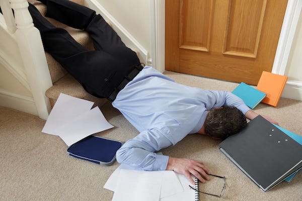 Businessman tripping walking down stairs