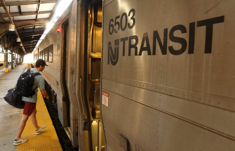 A man boards an NJ Transit train at the Hoboken Transit Terminal