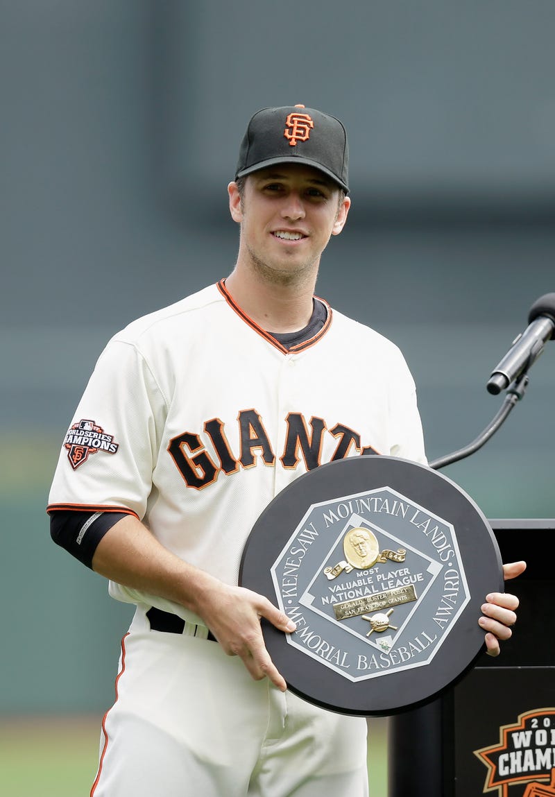 Buster Posey #28 of the San Francisco Giants holds the 2012 National League MVP Award during a pregame ceremony honoring him before the Giants game against the St. Louis Cardinals at AT&T Park on April 6, 2013 in San Francisco, California.