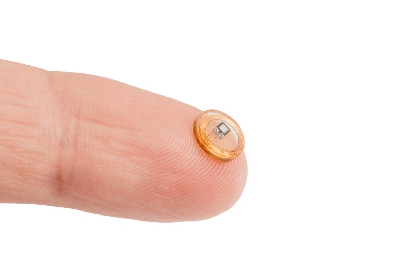 RFID tags that could be implanted in your hand. Stock photo. 