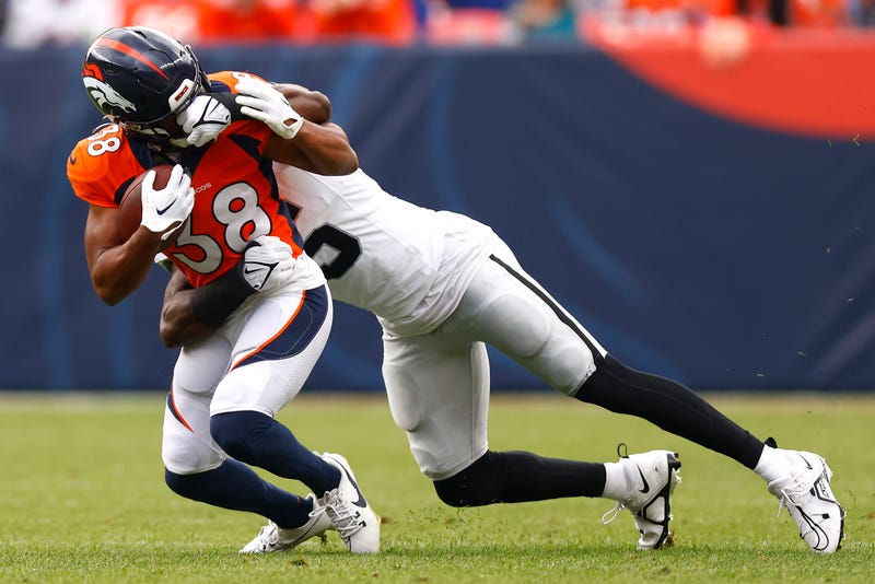 Divine Deablo #5 of the Las Vegas Raiders grabs the face mask of Jaleel McLaughlin #38 of the Denver Broncos during the second quarter at Empower Field At Mile High on September 10, 2023 in Denver