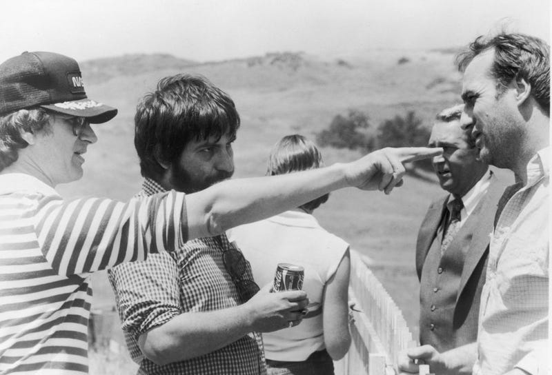 L-R: Producer (and uncredited director) Steven Spielberg points as director Tobe Hooper, actors James Karen and Craig T. Nelson listen on the set of the film, 'Poltergeist,' 1982.