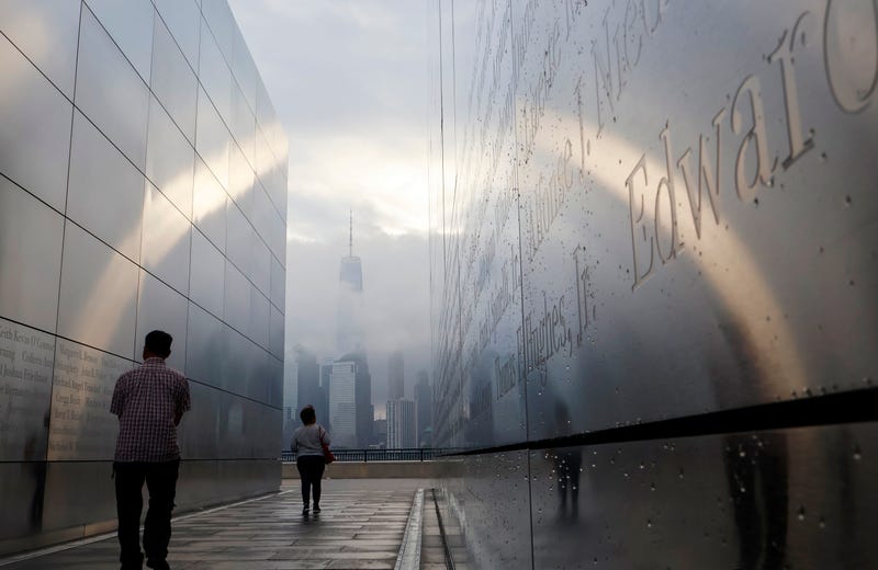 Visitors walk through the Empty Sky Memorial, New Jersey's official memorial to people from the state who were killed in the 9/11 attacks, on Sept. 11, 2023. One World Trade Center is visible in the background
