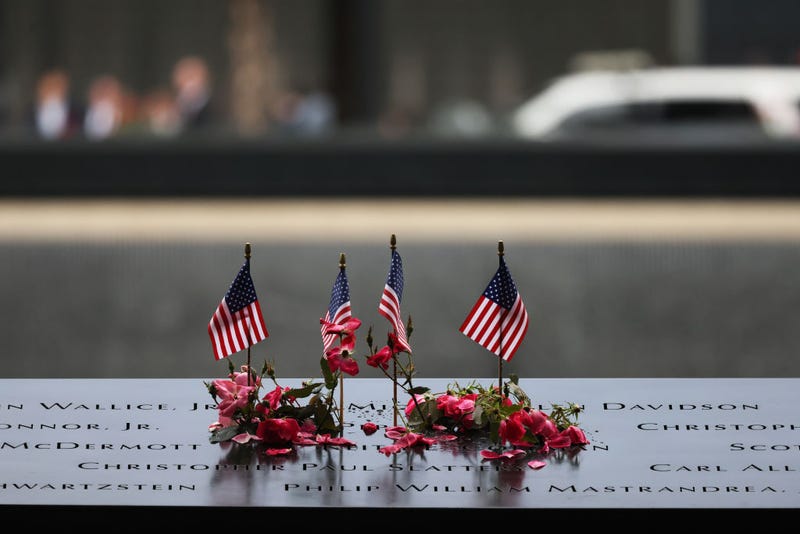 Flowers and flags are seen on the names of the victims of the 9/11 terror attack at the North Tower Memorial Pool during the annual 9/11 Commemoration Ceremony at the National 9/11 Memorial and Museum on September 11, 2023 in New York City.