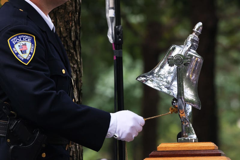 A Port Authority officer rings the bell at the time of the collapse of the North Tower during the annual 9/11 Commemoration Ceremony at the National 9/11 Memorial and Museum on September 11, 2023 in New York City.