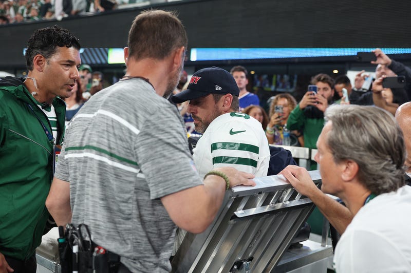 Quarterback Aaron Rodgers #8 of the New York Jets is helped onto a cart after an injury during the first quarter of the NFL game against the Buffalo Bills at MetLife Stadium on September 11, 2023 in East Rutherford, New Jersey.