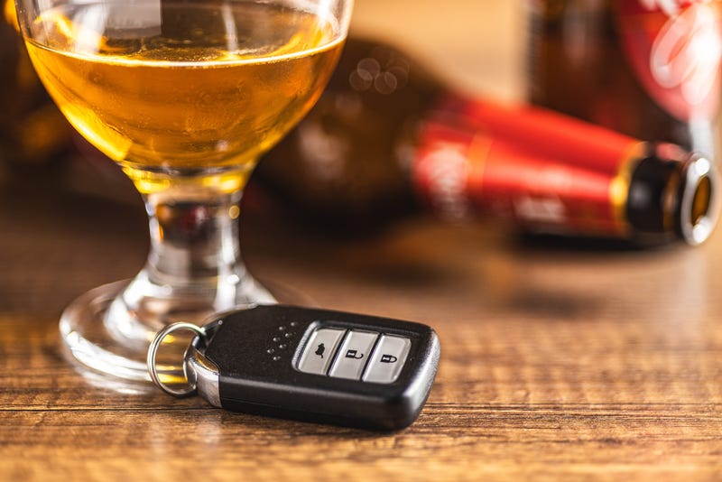 Beer next to car keys.