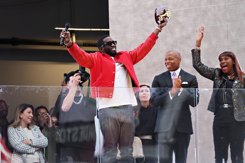 New York Mayor Eric Adams (R) presents Sean "Diddy" Combs with the keys to the city in Times Square on September 15, 2023 in New York City.