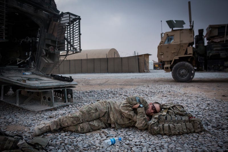 KANDAHAR, AFGHANISTAN - MARCH 18: A soldier in the U.S. Army's 1st Battalion, 36th Infantry Regiment, Charlie Company naps during a maintenance stop at Forward Operating Base Azzizulah on March 18, 2013 in Kandahar Province, Maiwand District, Afghanistan.