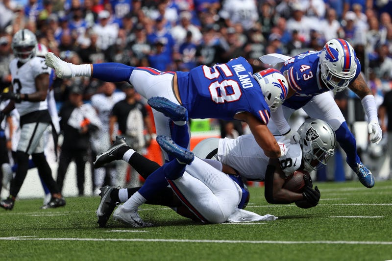 Matt Milano #58 of the Buffalo Bills and Terrel Bernard #43 of the Buffalo Bills tackle Josh Jacobs #8 of the Las Vegas Raiders during the second quarter at Highmark Stadium on September 17, 2023 in Orchard Park, New York.