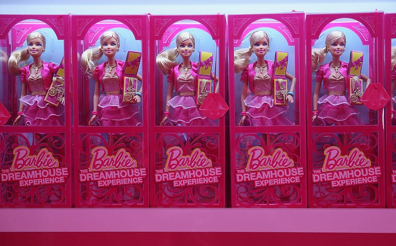 Barbie dolls and other souvenirs line shelves at the merchandising shop at the Barbie Dreamhouse Experience on May 16, 2013 in Berlin, Germany. 