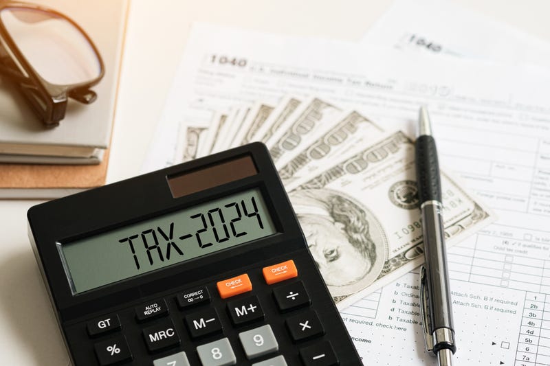 Word Tax 2024 on the calculator on documents.Income Statement. paying the tax rate. Taxation, taxes burden.Business and tax concept.