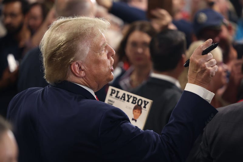 2024 Republican presidential candidate and former U.S. President Donald Trump holds a copy of the March 1990 Playboy magazine where he appears on the cover, as supporters ask for autographs following a "Commit To Caucus" rally at the Jackson County Fairgrounds on September 20, 2023 in Maquoketa, Iowa. The event is the first of two Trump has scheduled in Iowa today. (Photo by Scott Olson/Getty Images)