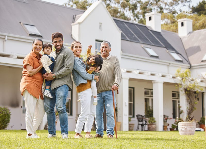 Happy family on the yard in front of their house