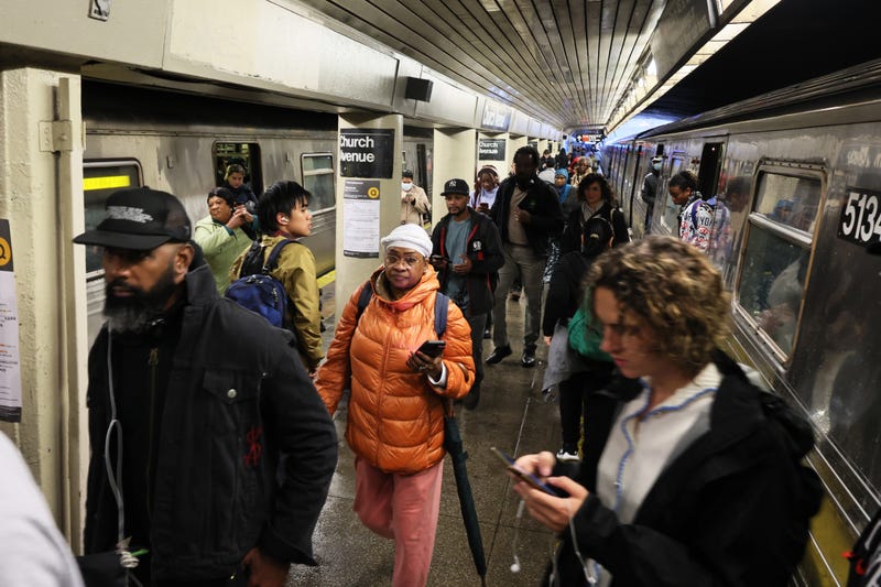 People stand around at the Church Avenue subway station as subway service is stopped amid heavy rain on September 29, 2023 in the Flatbush neighborhood of Brooklyn
