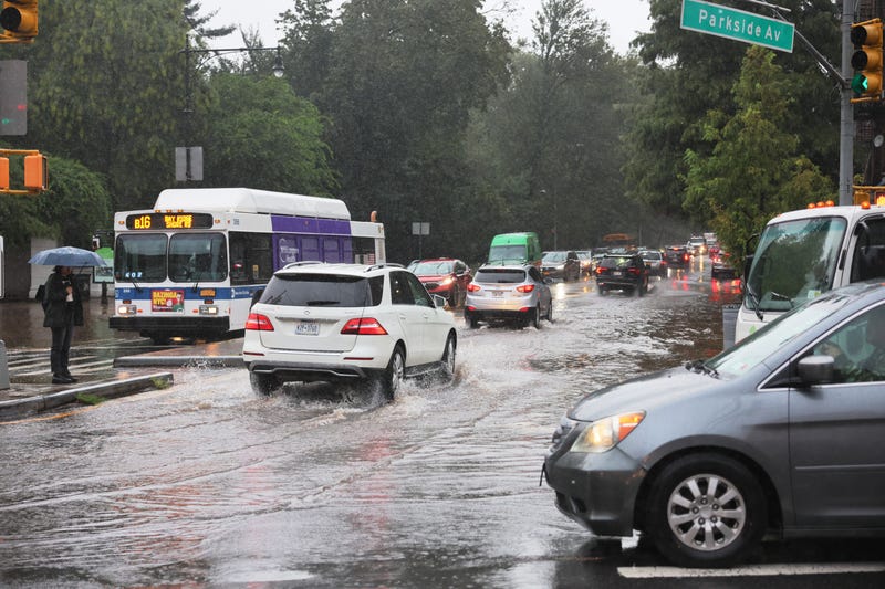 Cars drive through slight flooding on Ocean Avenue amid heavy rain on September 29, 2023 in the Flatbush neighborhood of Brooklyn