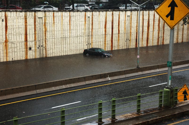 A vehicle sits submerged after it got stuck in high water on the Prospect Expressway during heavy rain and flooding on September 29, 2023 in the Brooklyn Borough of New York City.