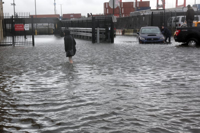 A woman walks through the flooded streets in the Red Hook neighborhood on September 29, 2023.