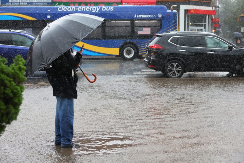 A person makes a video of a flood water on Parkside Avenue on Sept. 29, 2023 in the Flatbush neighborhood of Brooklyn.