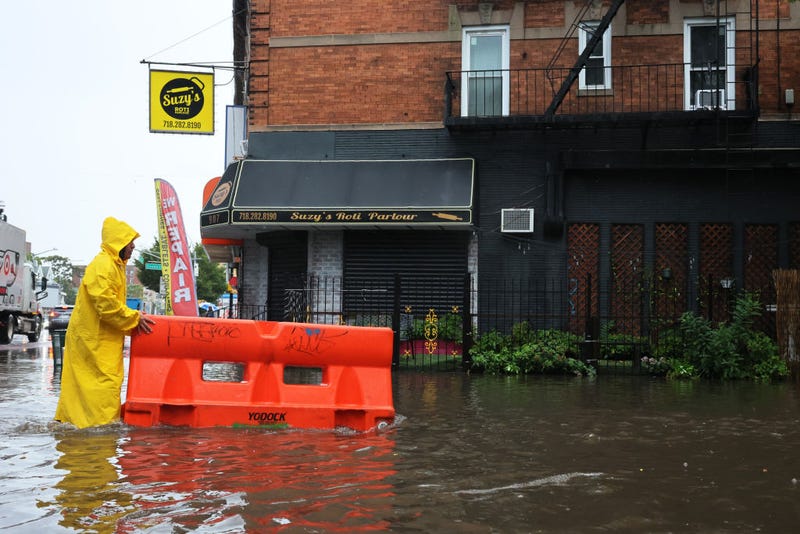 A person makes a video of a flood water on Parkside Avenue on Sept. 29, 2023 in the Flatbush neighborhood of Brooklyn.